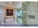 Luxurious primary bathroom featuring a glass enclosed shower, soaking tub, and modern fixtures at 4712 Stavanger Ln, Las Vegas, NV 89147
