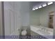 Powder room featuring a white vanity with modern fixtures, a toilet, and a large mirror at 4712 Stavanger Ln, Las Vegas, NV 89147