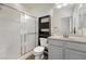 Bathroom with a glass enclosed shower, neutral colored walls, toilet and storage shelves at 4755 S Santa Fiora St, Pahrump, NV 89061