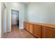 Hallway with tile floors, built-in cabinets and a laundry room at the end of the hall at 4755 S Santa Fiora St, Pahrump, NV 89061