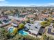 Aerial view of neighborhood homes, swimming pools, mature landscaping and mountain views at 5050 Grandview Dr, Las Vegas, NV 89120