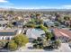 Neighborhood aerial view with lush landscaping, swimming pools and mountain views at 5050 Grandview Dr, Las Vegas, NV 89120