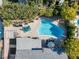 Aerial view of backyard pool, lounge seating, mature trees and covered patio at 5050 Grandview Dr, Las Vegas, NV 89120