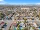 City aerial view showcasing community homes with mature trees, sparkling pools and city skyline at 5050 Grandview Dr, Las Vegas, NV 89120