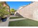 Backyard with manicured artificial turf, mature landscaping and privacy wall at 5050 Grandview Dr, Las Vegas, NV 89120