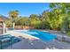 Gorgeous backyard with a sparkling pool, surrounded by mature trees and plants for privacy and relaxation at 5050 Grandview Dr, Las Vegas, NV 89120