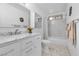 Bright bathroom with vanity sink and a shower with glass doors and decorative marble-look tile at 5050 Grandview Dr, Las Vegas, NV 89120