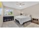 Comfortable bedroom features neutral walls, carpet, ceiling fan, and natural light from a large window at 5050 Grandview Dr, Las Vegas, NV 89120