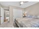 Well-lit bedroom features plush carpeting, ceiling fan and a large closet with white sliding doors at 5050 Grandview Dr, Las Vegas, NV 89120