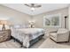 Comfortable bedroom features neutral walls, carpet, a chair and natural light from a large window at 5050 Grandview Dr, Las Vegas, NV 89120