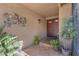 View of the home's unique front door, sconce lighting, and front porch plants at 5050 Grandview Dr, Las Vegas, NV 89120
