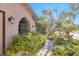 Close-up view of the home's entryway with wrought iron and unique landscaping at 5050 Grandview Dr, Las Vegas, NV 89120