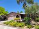 Charming home with mature landscaping, including vibrant yellow flowers at 5050 Grandview Dr, Las Vegas, NV 89120
