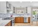 Modern kitchen with stainless steel appliances, designer tile backsplash and wood-look floors at 5050 Grandview Dr, Las Vegas, NV 89120