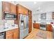 Renovated kitchen with stainless steel appliances, contrasting white and wood cabinets, and ample storage at 5050 Grandview Dr, Las Vegas, NV 89120