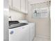 Laundry room featuring white washer and dryer and updated cabinets at 5050 Grandview Dr, Las Vegas, NV 89120
