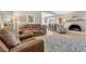 Comfortable living room with a brick fireplace, wood-look floors and sliding glass doors to the backyard at 5050 Grandview Dr, Las Vegas, NV 89120