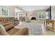 Inviting living room features a brick fireplace, wood-look floors and sliding glass doors to the backyard at 5050 Grandview Dr, Las Vegas, NV 89120