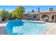 Sparkling backyard pool with a tanning ledge, lounge chairs, and lush greenery for ultimate relaxation at 5050 Grandview Dr, Las Vegas, NV 89120