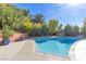 Beautiful swimming pool with lush greenery, flowers, and ample space for outdoor enjoyment at 5050 Grandview Dr, Las Vegas, NV 89120