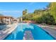 Inviting backyard pool with lush landscaping, an umbrella-covered table, and a diving board for summer fun at 5050 Grandview Dr, Las Vegas, NV 89120