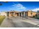 A single story red brick home showcases a spacious concrete driveway and well kept front yard at 5162 Woodruff Pl, Las Vegas, NV 89120