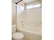 This well-lit bathroom features a shower and bathtub combination with white tiling at 5236 El Prado Heights St, North Las Vegas, NV 89081