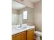 Well-lit bathroom featuring a large mirror, a white countertop, a sink, and a toilet at 5236 El Prado Heights St, North Las Vegas, NV 89081
