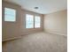 A bright bedroom with three windows and carpeted flooring at 5236 El Prado Heights St, North Las Vegas, NV 89081