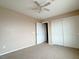 This bedroom features a ceiling fan, closet, and neutral walls, creating a bright and airy feel at 5236 El Prado Heights St, North Las Vegas, NV 89081