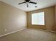 Neutral bedroom featuring a ceiling fan and a large window at 5236 El Prado Heights St, North Las Vegas, NV 89081