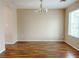 A spacious dining room featuring hardwood floors and a classic chandelier at 5236 El Prado Heights St, North Las Vegas, NV 89081