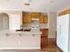 Bright kitchen featuring wood cabinets, a white gas range stove, a kitchen island, and wood flooring at 5236 El Prado Heights St, North Las Vegas, NV 89081