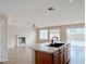 Open floorplan featuring a kitchen island with a sink and a cozy living room with fireplace at 5236 El Prado Heights St, North Las Vegas, NV 89081