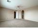 A large open living room showcasing an open floor plan with tan walls and neutral carpet at 5236 El Prado Heights St, North Las Vegas, NV 89081