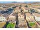 An aerial view of a desert community featuring houses and scenic mountains in the background at 589 Via Medici, Henderson, NV 89011