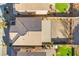 An aerial view of a home displaying the roof, backyard, and desert landscaping at 589 Via Medici, Henderson, NV 89011