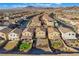 An aerial view of a desert community featuring houses and scenic mountains in the background at 589 Via Medici, Henderson, NV 89011