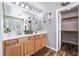 A bathroom with double sinks and a walk-in closet at 589 Via Medici, Henderson, NV 89011