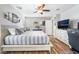 A bedroom with neutral walls features a ceiling fan and space for both a bed and an office at 589 Via Medici, Henderson, NV 89011