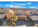 Charming two-story home with a well-maintained front yard and desert landscaping at 589 Via Medici, Henderson, NV 89011