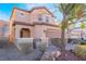 Beautiful two-story home featuring desert landscaping and an attached two-car garage at 589 Via Medici, Henderson, NV 89011