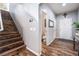 Welcoming foyer adjacent to wooden staircase and including hardwood floors and half bathroom at 589 Via Medici, Henderson, NV 89011