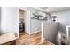 A hallway with wood-style laminate floors and decorative shelving and a washer and dryer at the end at 589 Via Medici, Henderson, NV 89011