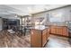 A well-lit kitchen features stainless steel appliances, a center island, and wood-style laminate flooring at 589 Via Medici, Henderson, NV 89011