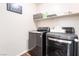 Convenient laundry room with modern washer and dryer and upper shelving at 589 Via Medici, Henderson, NV 89011