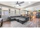 Comfortable living room featuring a large sectional sofa and an open floor plan to kitchen at 589 Via Medici, Henderson, NV 89011