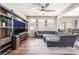 Spacious living room with a large sectional sofa and a modern entertainment center at 589 Via Medici, Henderson, NV 89011