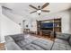 Bright and airy living room featuring a large entertainment center, a sectional sofa, and hardwood floors at 589 Via Medici, Henderson, NV 89011