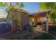 A covered patio in the backyard provides shade for outdoor seating, surrounded by desert landscaping and an iron fence at 6061 Leaping Foal St, North Las Vegas, NV 89081